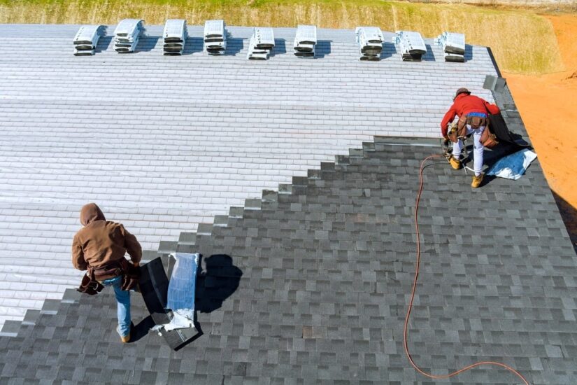 Worker Applying Shingles To A Roof