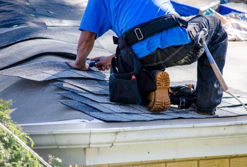 Worker Fixing Asphalt Shingles